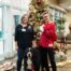 Members of Alliance of Therapy Dogs pose at Christmas tree with dog.