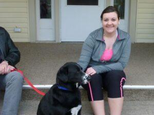 woman smiles for photo with dog - thanksgiving