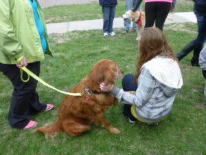 pet therapy dog with teen crouch together at ATD event