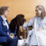 An ATD Member sits next to her chocolate colored dog who visits with a Mayo Clinic patient
