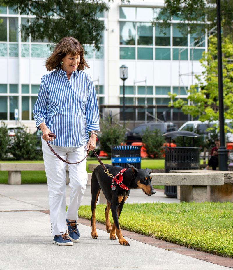 therapy dog owner walking her dog outside of hospital