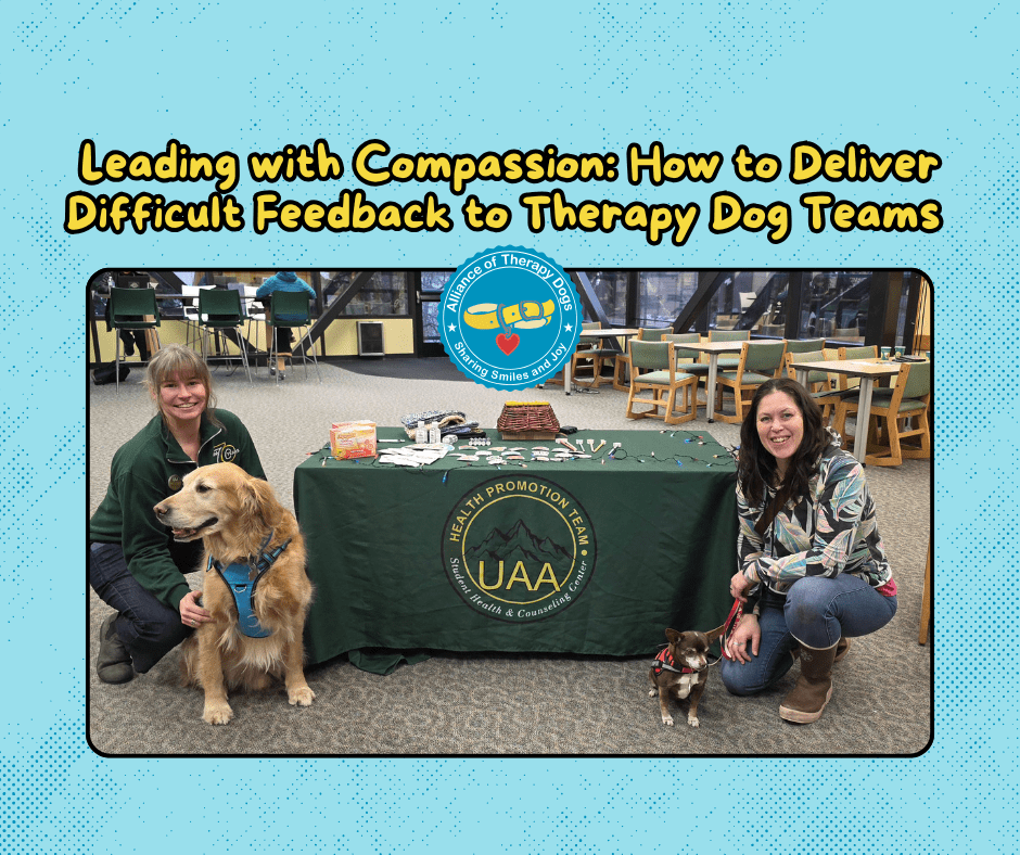 Two ATD teams kneel by a table with their therapy dogs smiling.