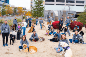a variety of therapy dog teams are sitting in front of the facility.